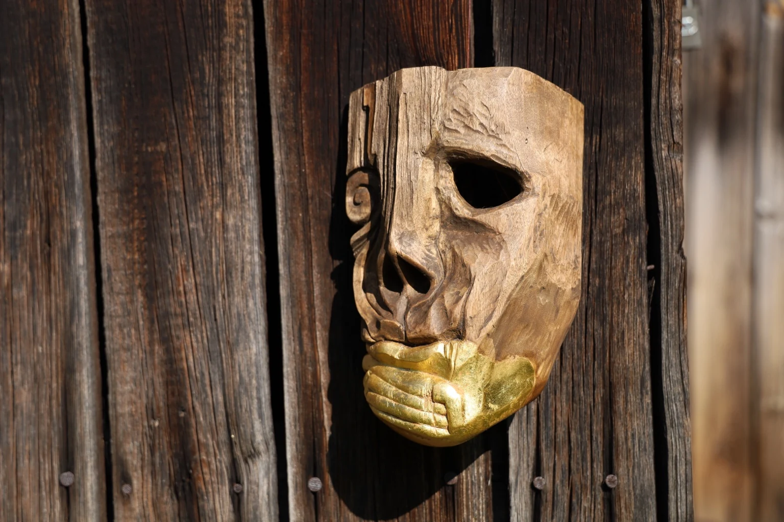 Kurtz, a carved oak mask with a gilded mouth.